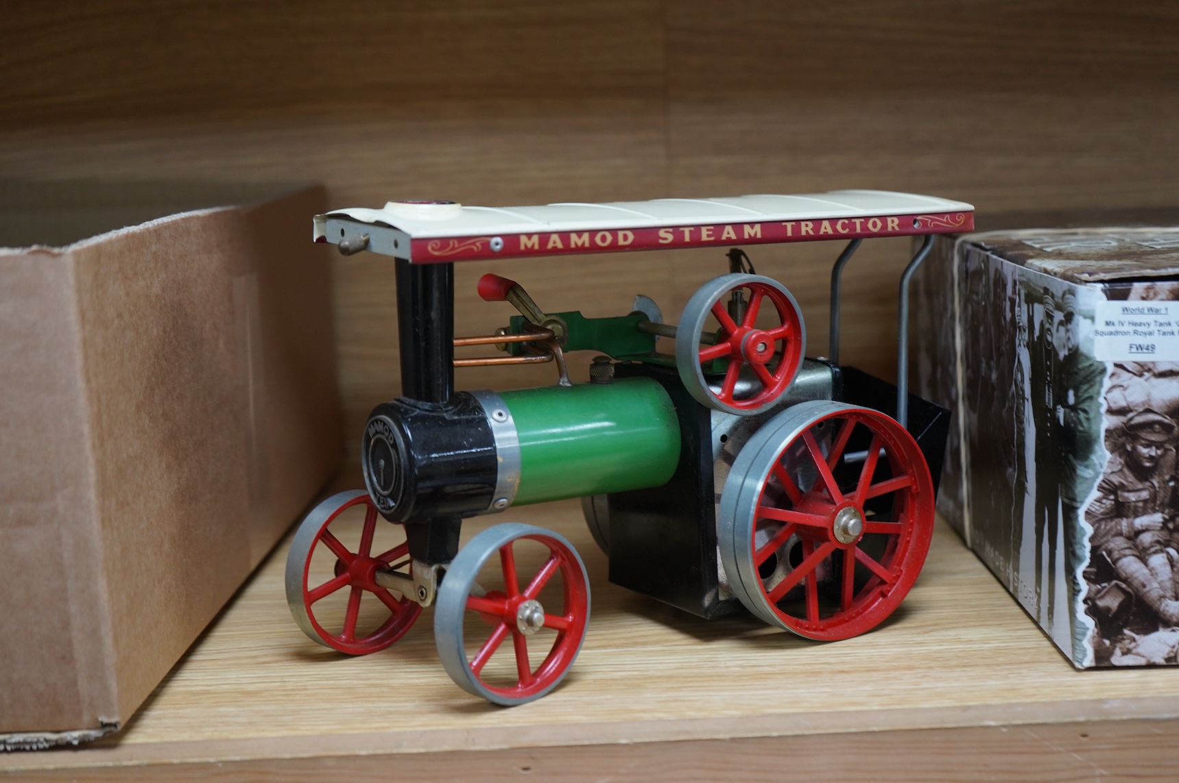 A boxed Mamod T.E.1a Steam Tractor, a boxed Britains 18” Howitzer field gun (2107), and a tinplate machine gunner (3)